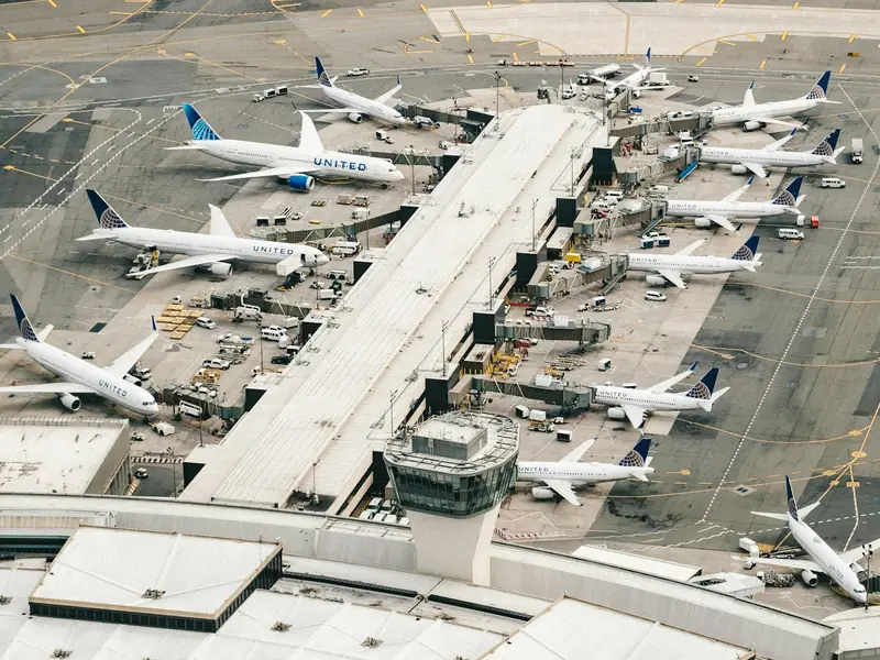 Aerial view of aircraft parked at the gates of an airport terminal