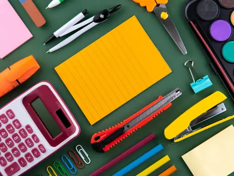 Office and school supplies laid out on a desk