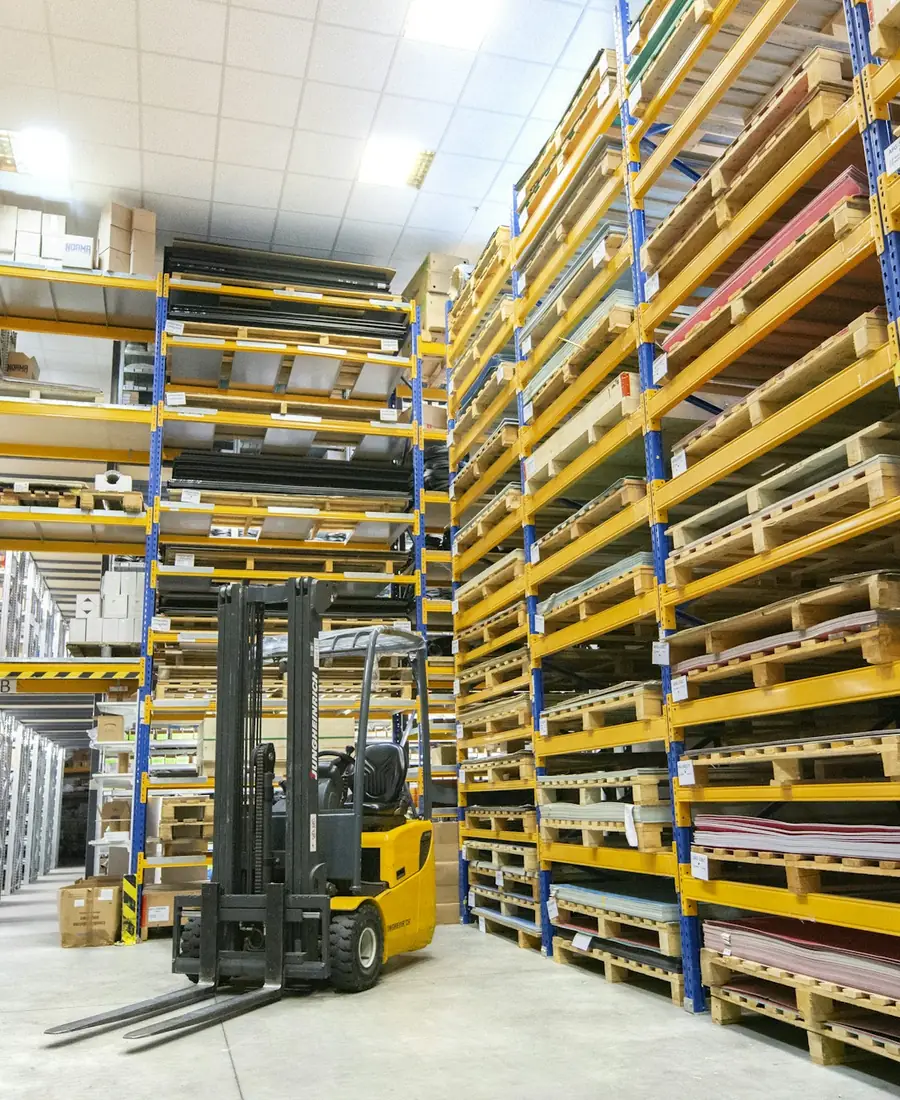 Forklift working in a warehouse aisle of pallet racking