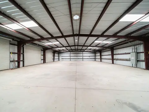 Clean, empty industrial hall lit by overhead lighting
